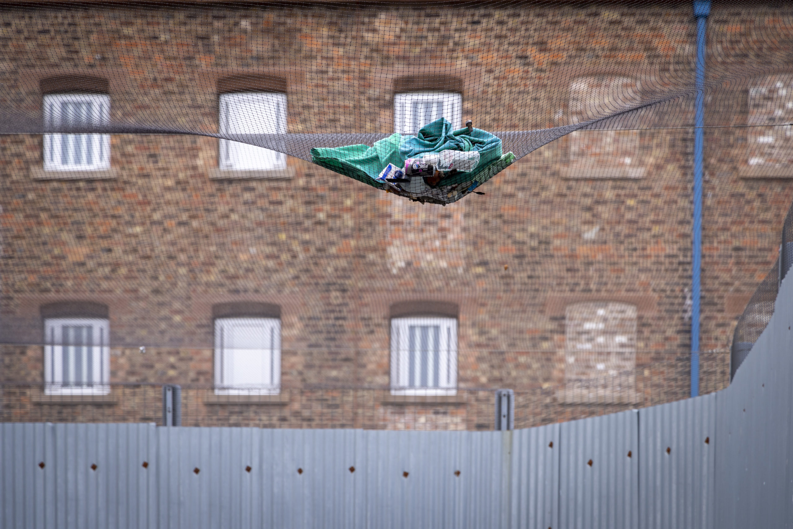 Bed sheet and rubbish on the security netting above K-wing exercise yard inside HMP Liverpool. Andy Aitchison